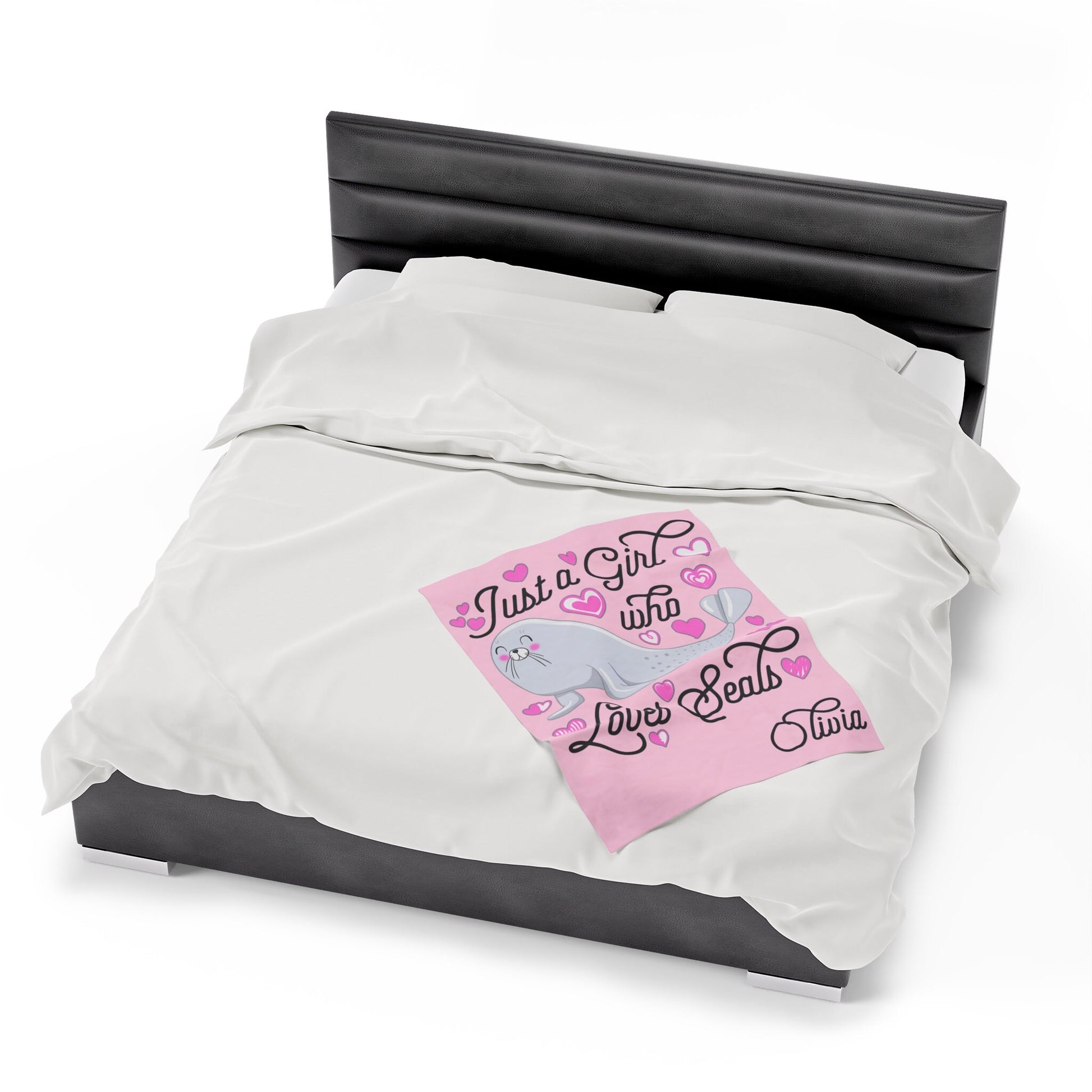 a bed with a pink and white comforter and a black headboard