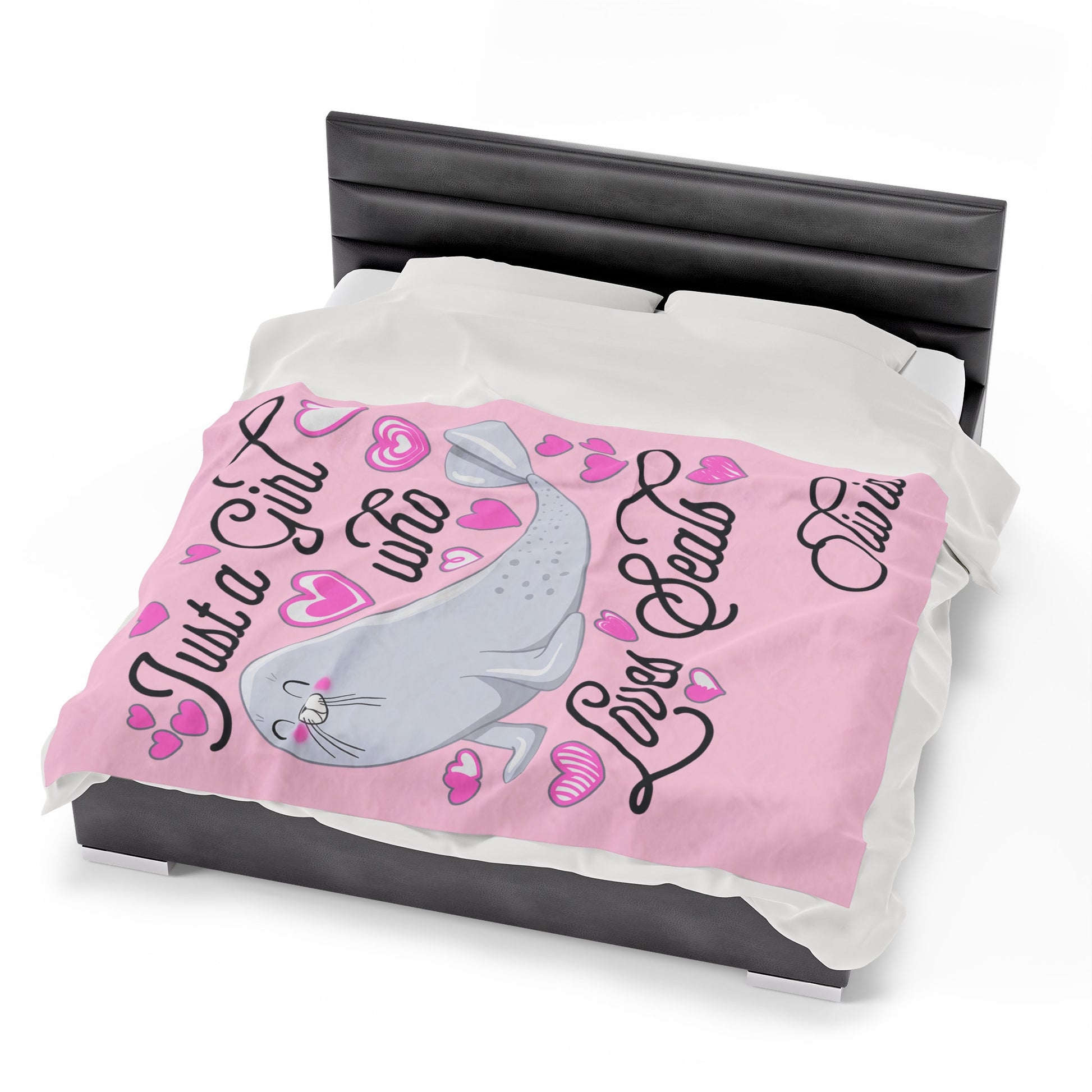 a bed with a pink comforter with a seal on it