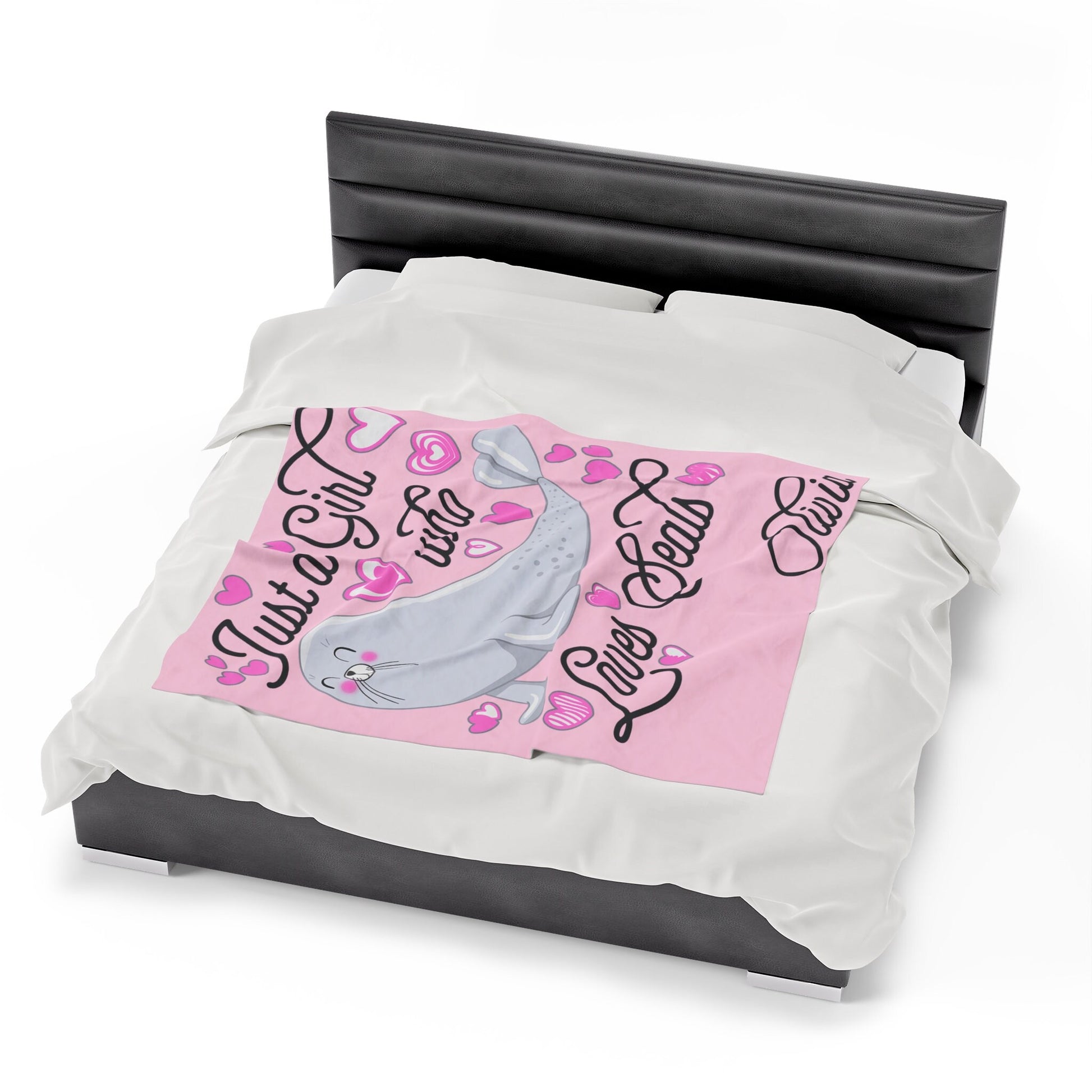 a bed with a pink and white comforter on top of it