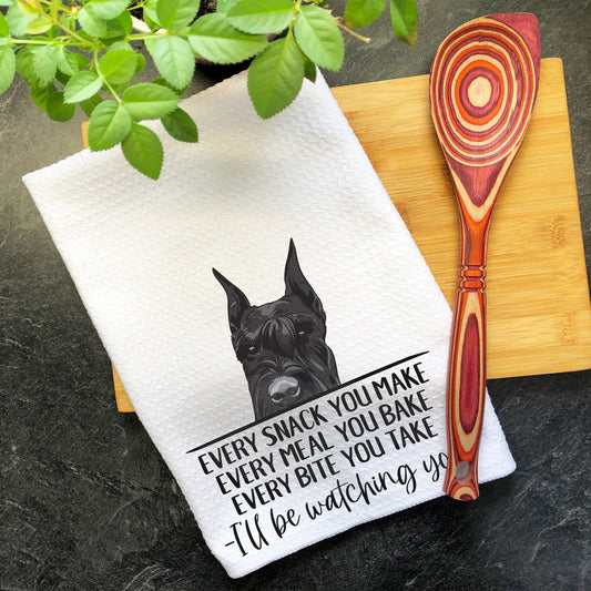 a kitchen towel with a black dog on it