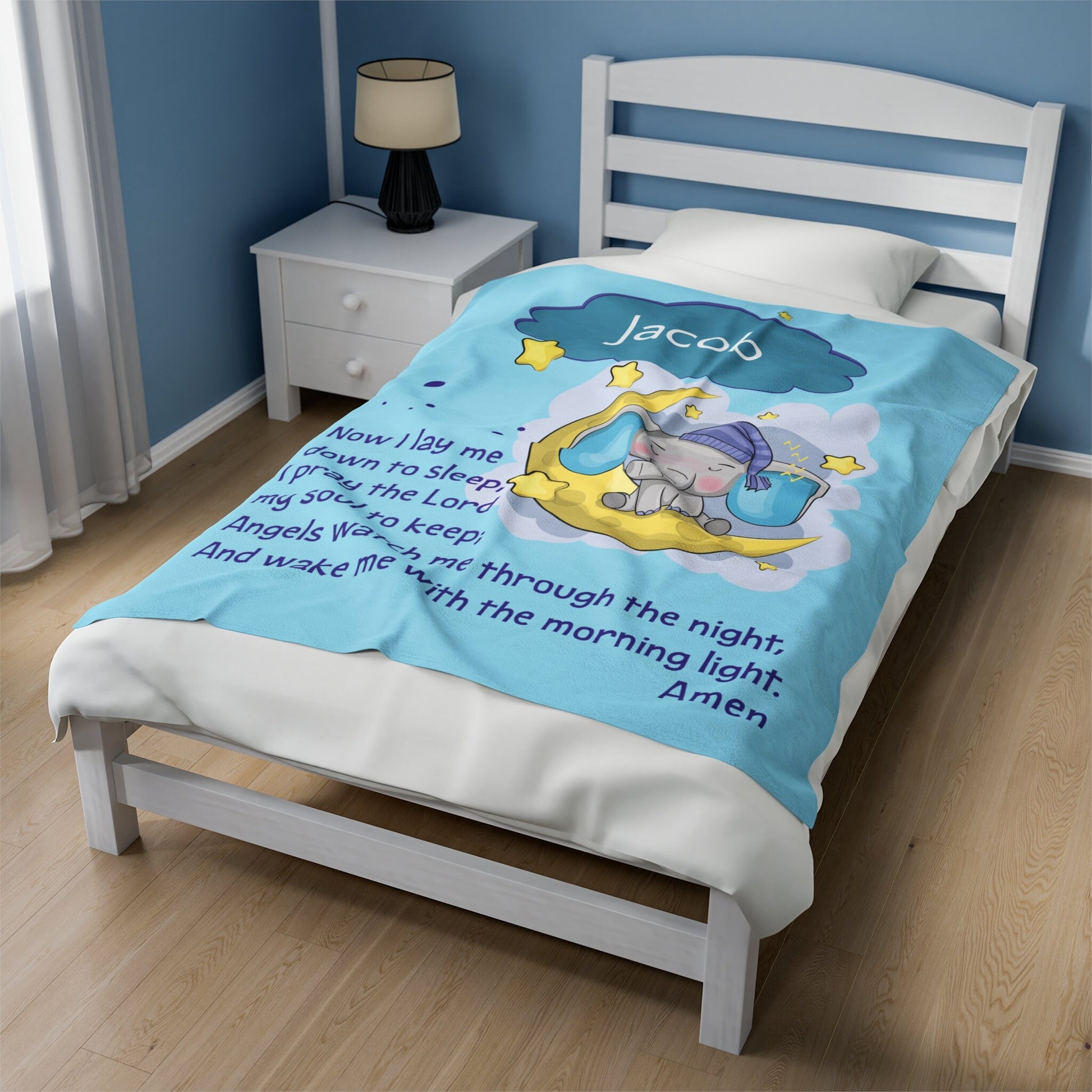 a bed with a blue comforter with a picture of a little mermaid on it