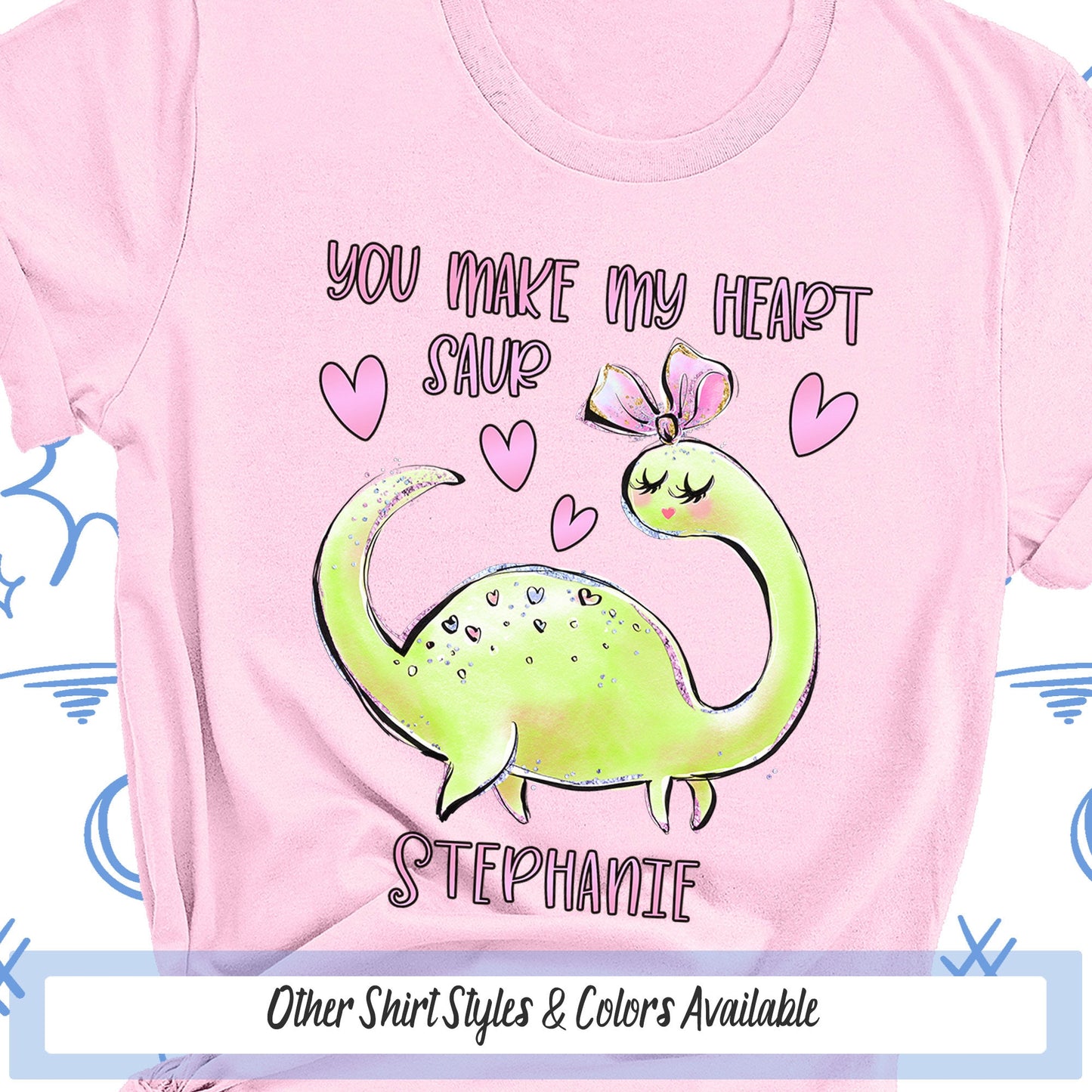 a pink shirt with a green dinosaur on it