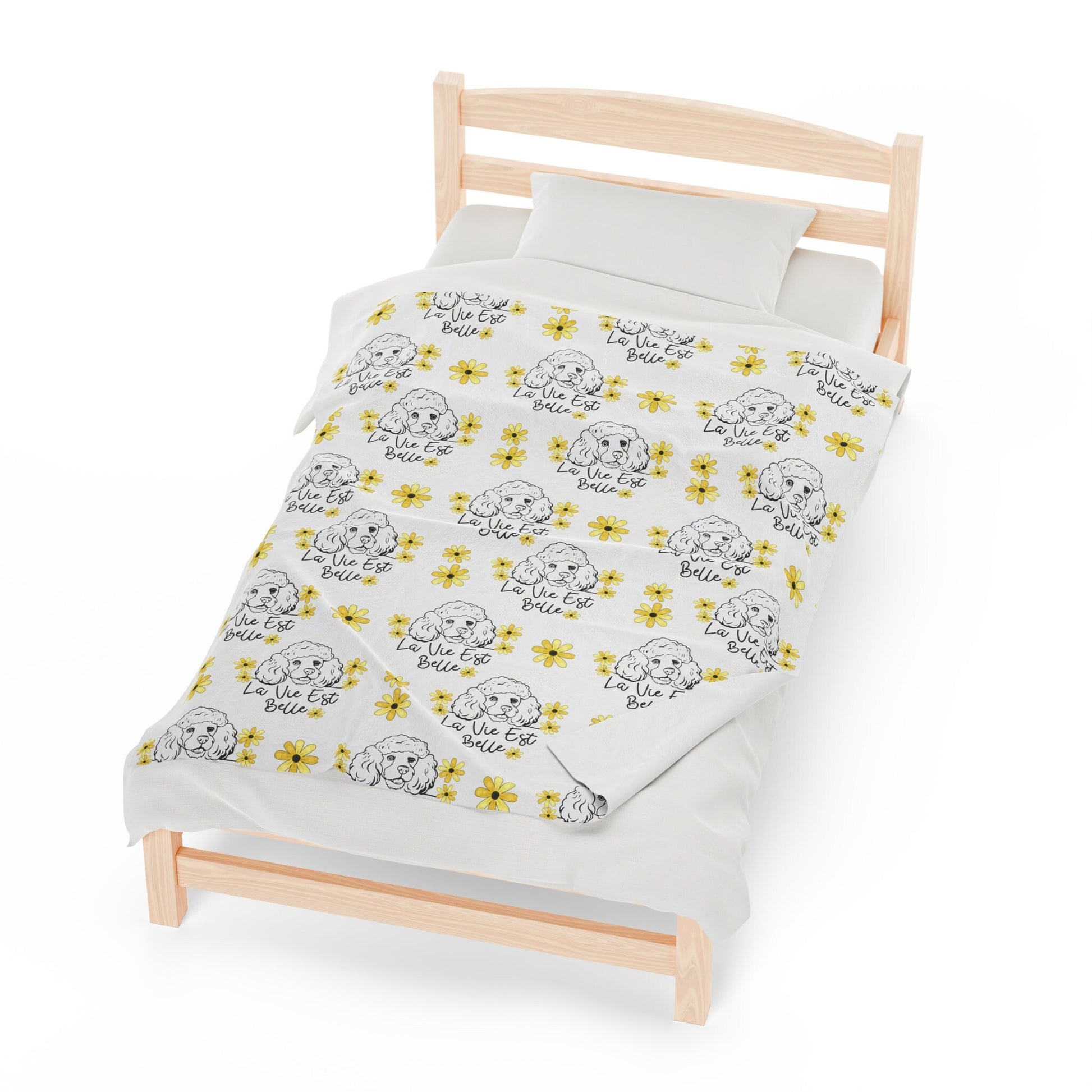 a bed with a white sheet and yellow flowers on it