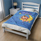 a bed with a blue comforter with a lion on it