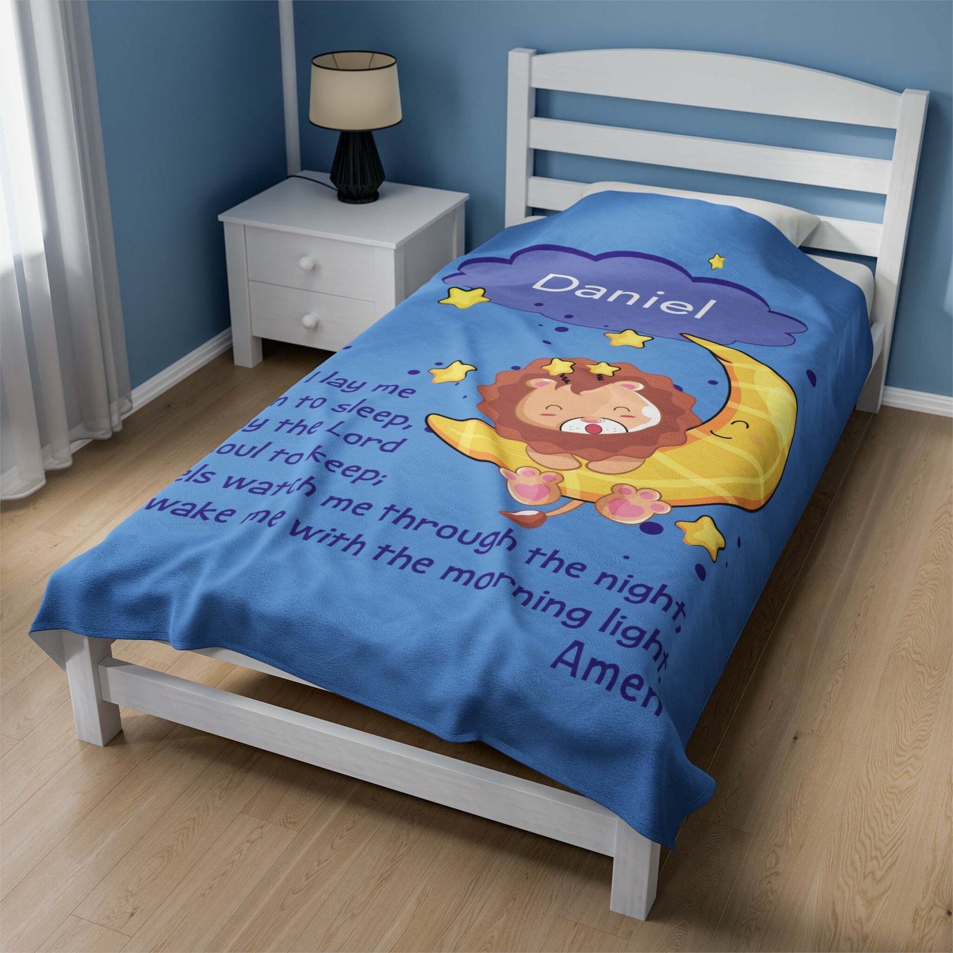a child's bed with a blue comforter with a lion on it