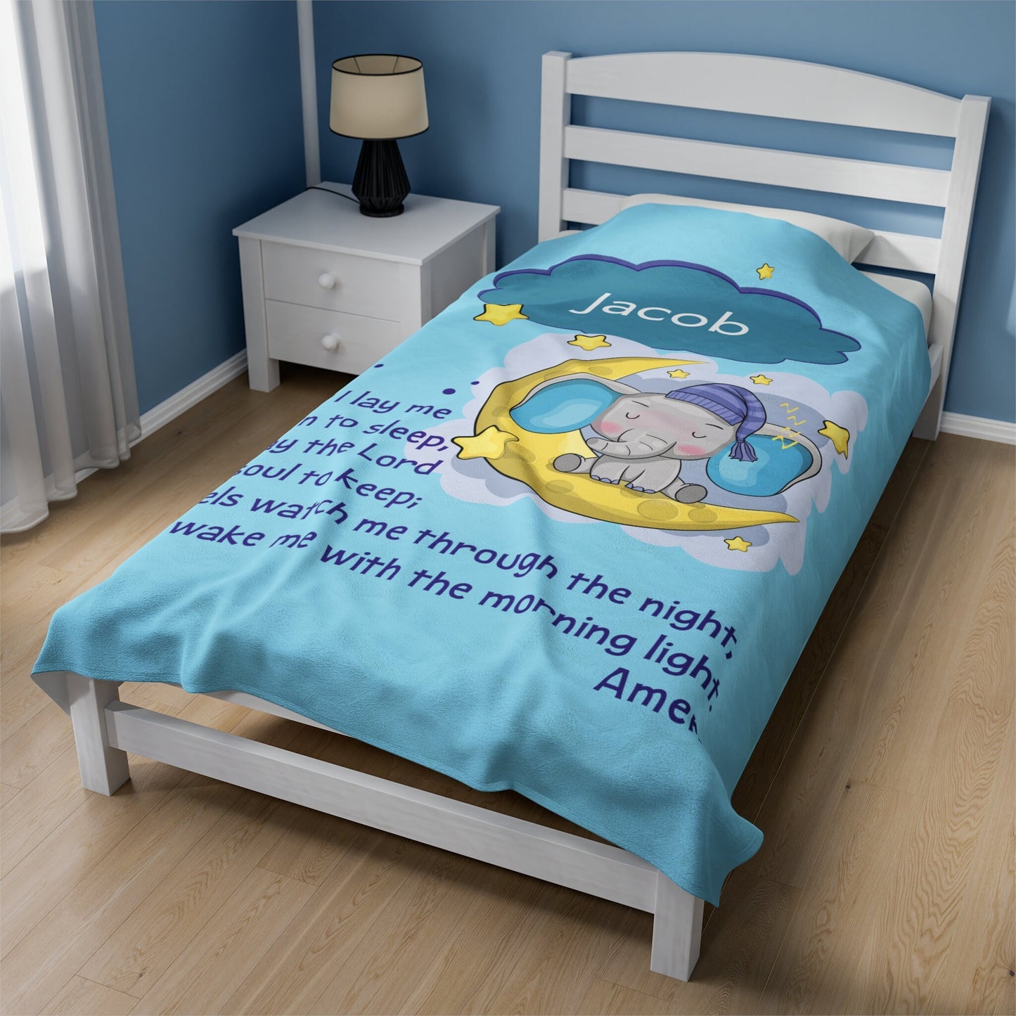 a child's bed with a blue comforter with an elephant on it