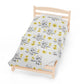 a small wooden bed with a white sheet with yellow flowers on it