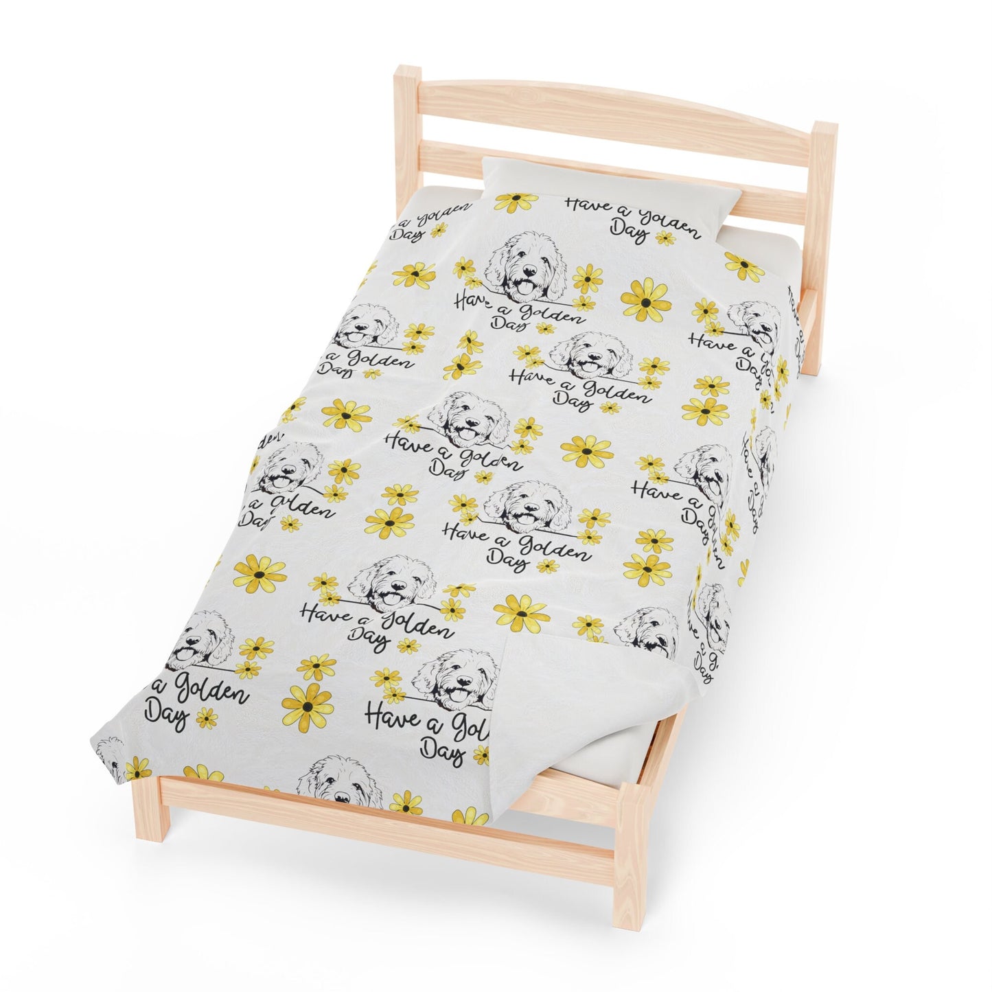 a small wooden bed with a white sheet with yellow flowers on it