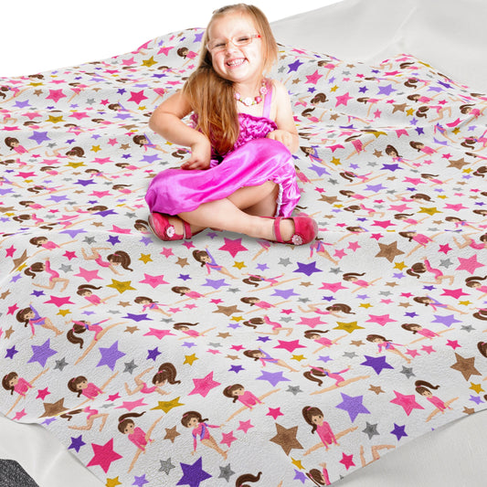 a little girl sitting on top of a bed covered in stars