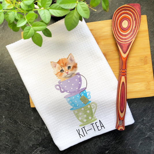 a tea towel with a picture of a kitten on it