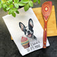 a tea towel with a picture of a dog and a cupcake on it