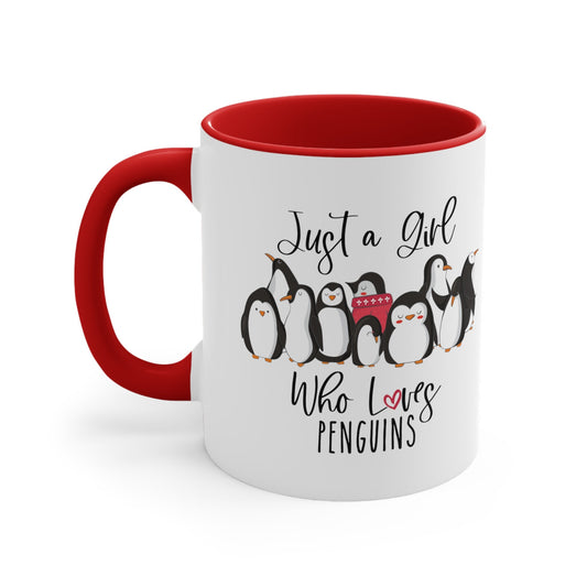 a red and white coffee mug with penguins on it