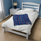 a bed with a blue blanket on top of it