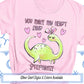 a pink shirt with a green dinosaur on it