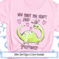 a pink shirt with a green dinosaur on it