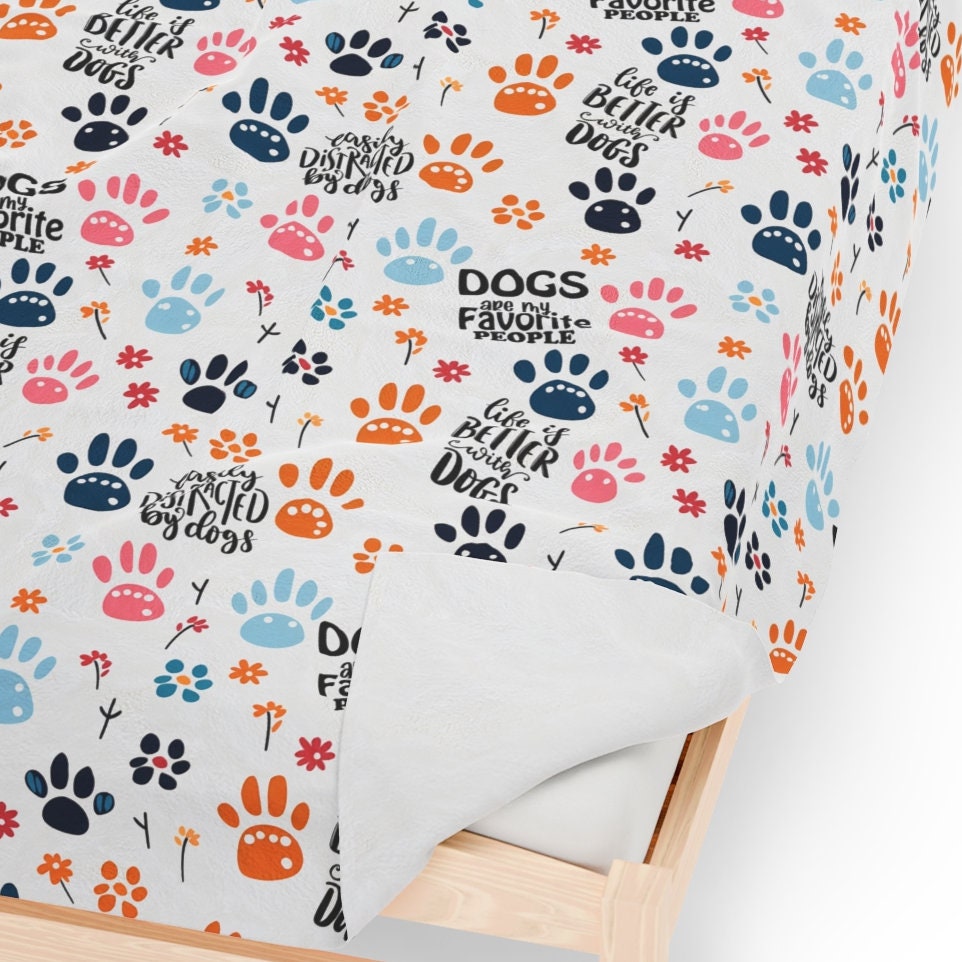 a bed with a dog paw print on it