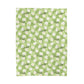 a green and white checkered pattern with daisies