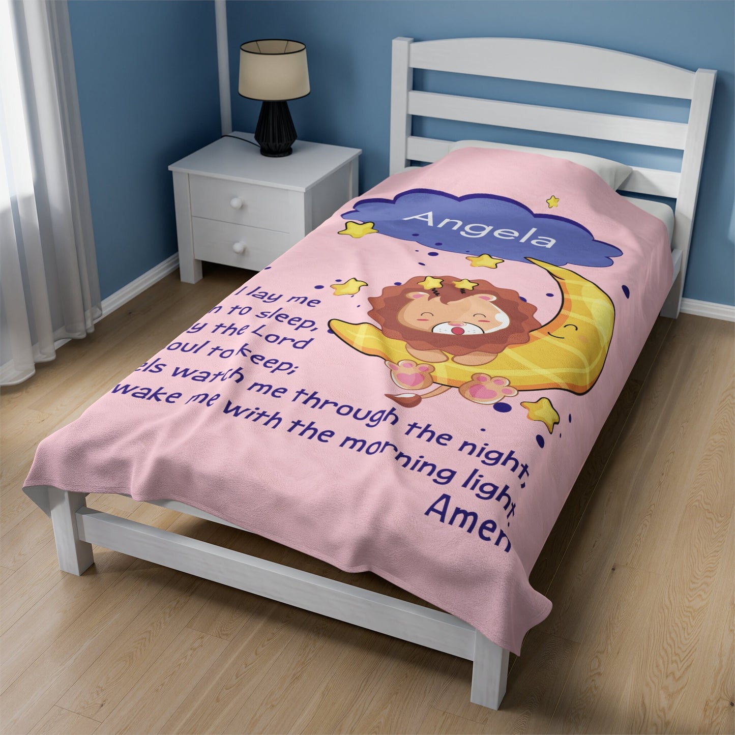 a bed with a pink comforter with a lion on it