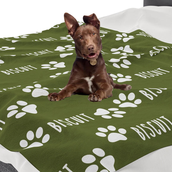 a brown dog laying on top of a green blanket