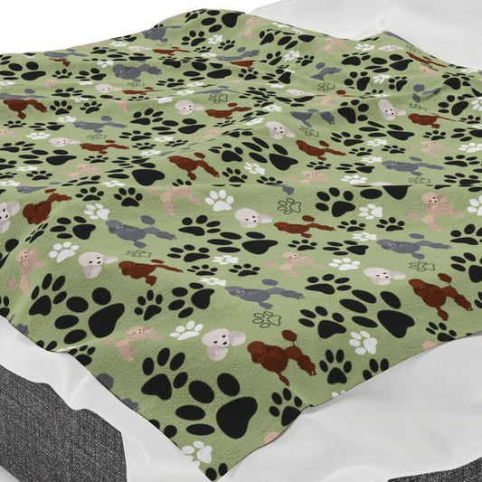 a dog paw print blanket on a bed