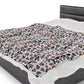 a bed with a black headboard and white sheets