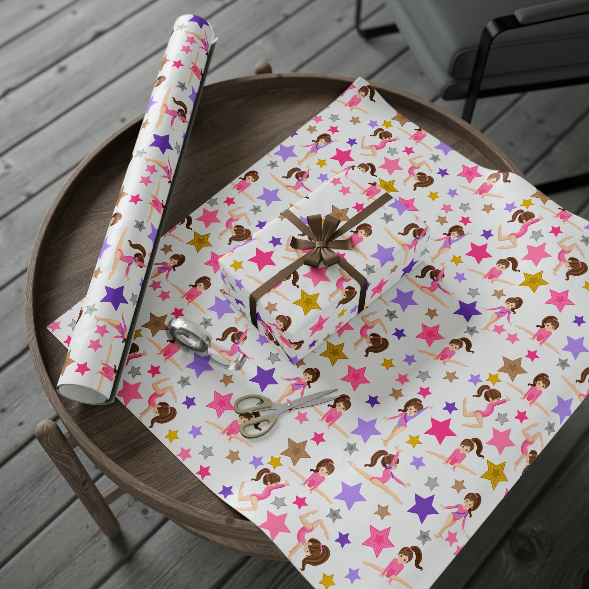 a table with a wrapping paper and scissors on it